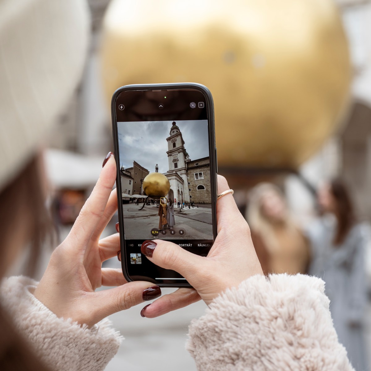 Tourist takes a photo of sights in Salzburg with a smartphone.