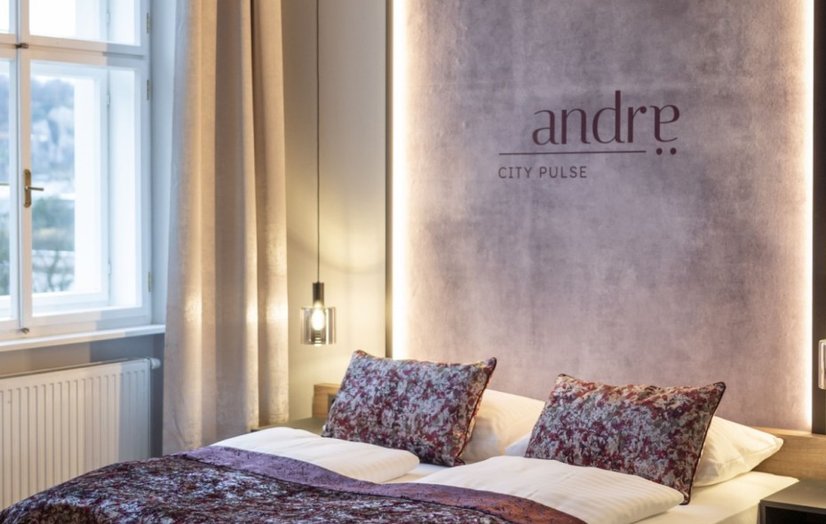 Signature room with city view at Hotel Andrae, featuring a box-spring bed and modern furnishings in the middle of Salzburg city center in a quiet location.